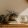 bureau top decorated with potted plants, books and framed pictures