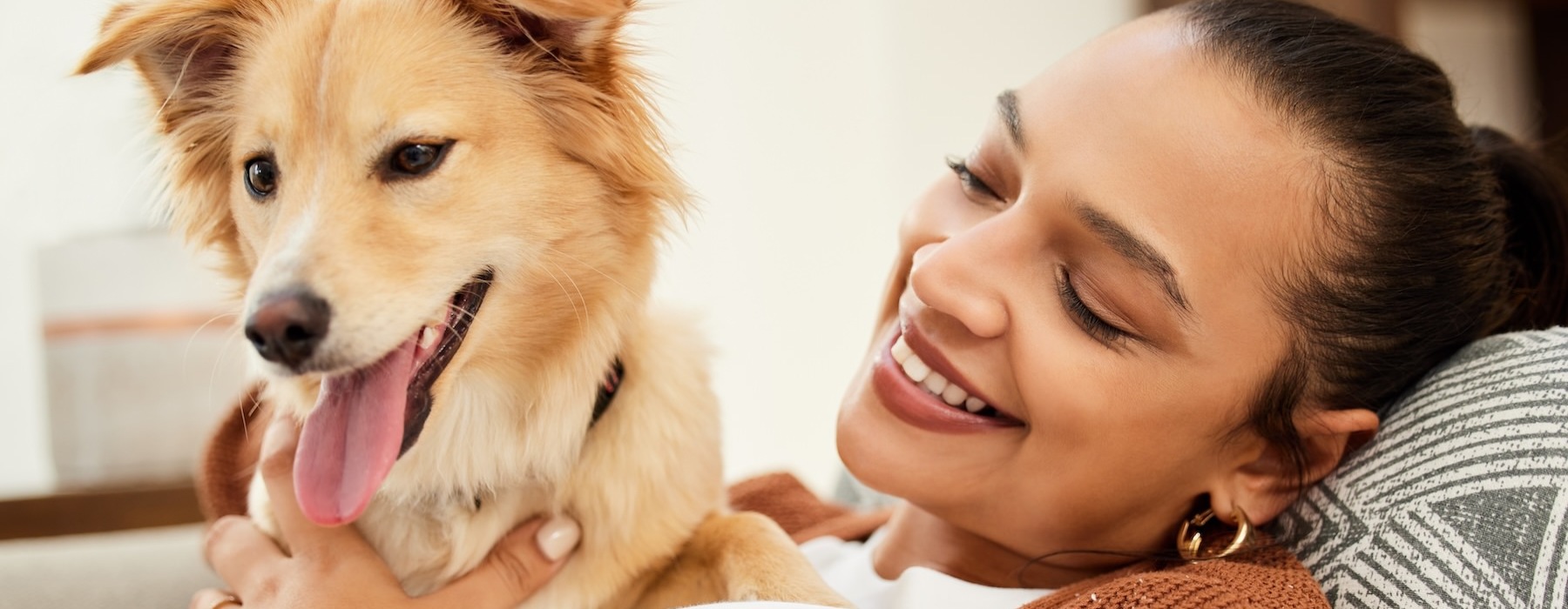 a person lying on a couch with a dog