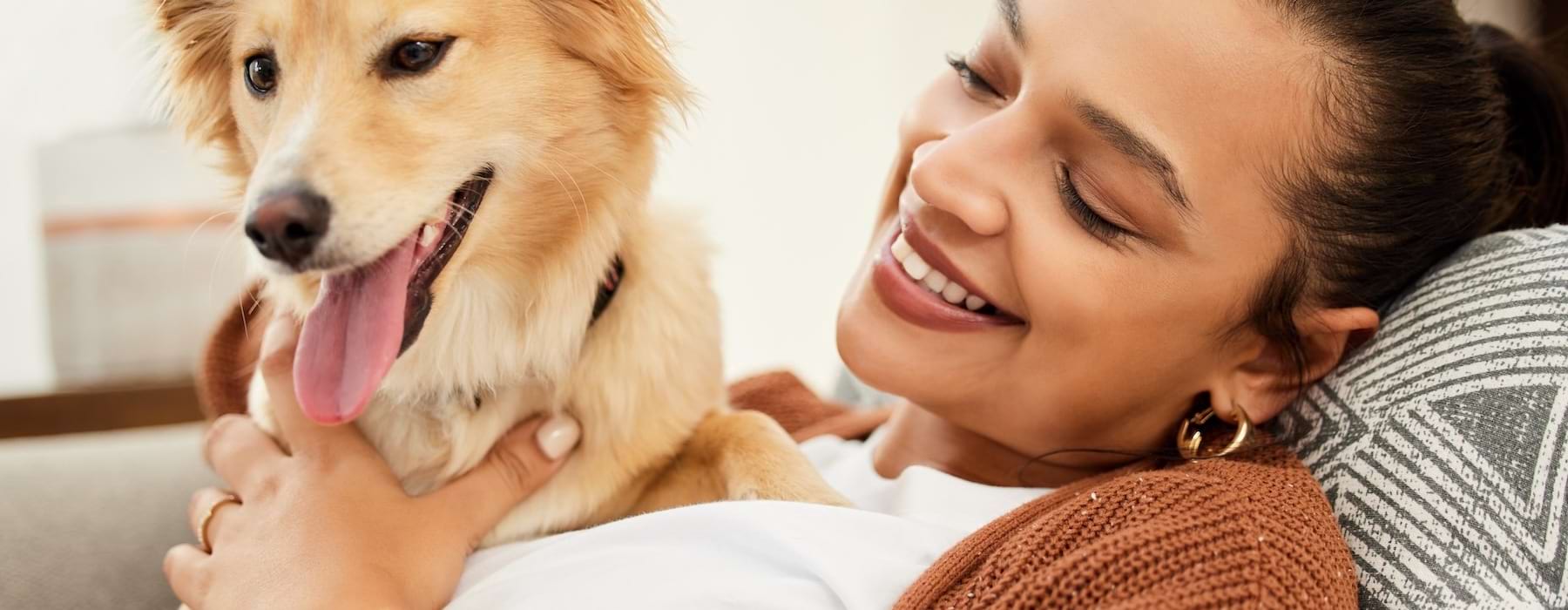 a person lying on a couch with a dog