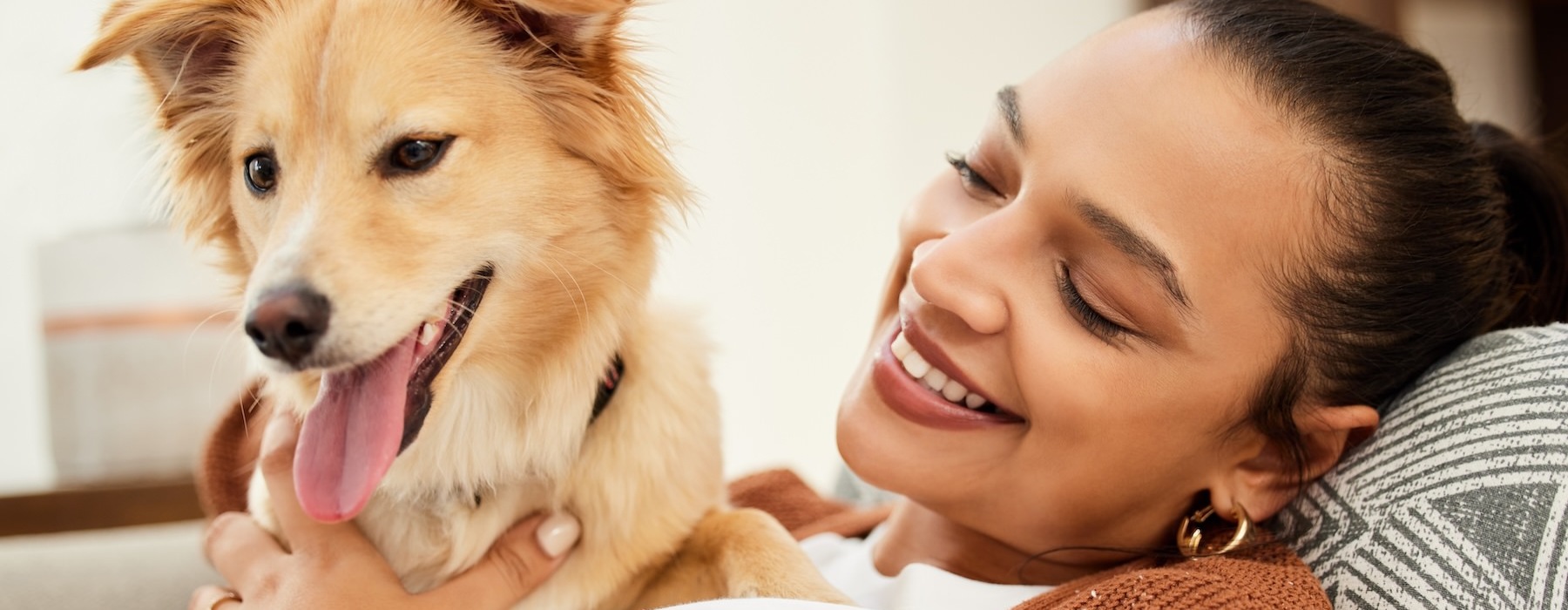 a person lying on a couch with a dog